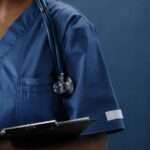 a stethoscope on a medical professional s shoulder