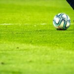 man playing soccer game on field