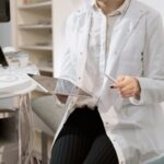 Doctor holding a tablet in a modern medical office during a patient consultation.